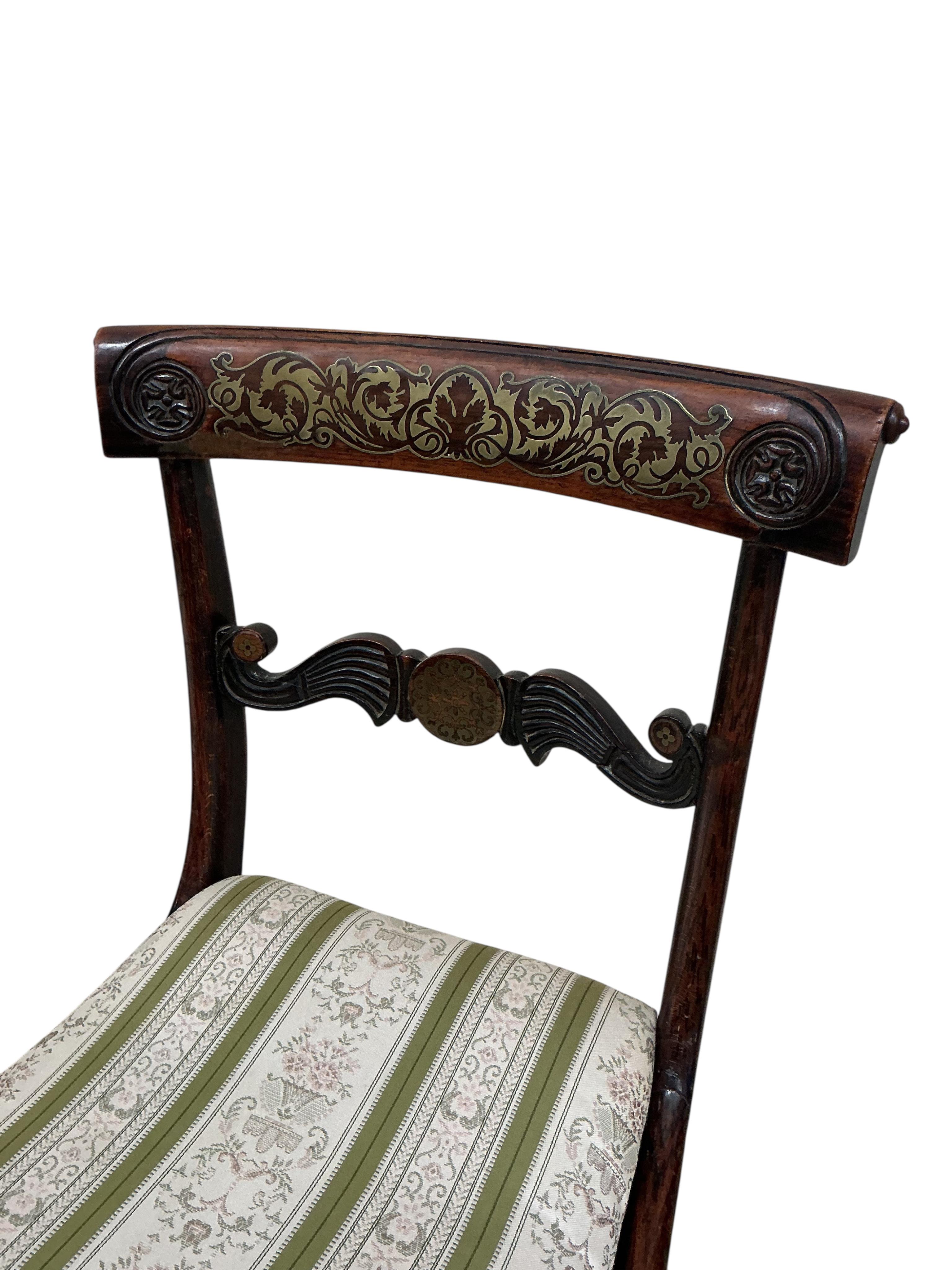 A set of four Regency brass inlaid simulated rosewood dining chairs